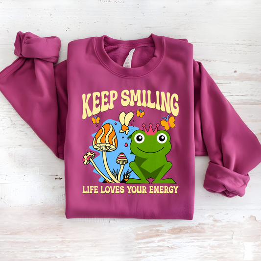 Cute unisex sweatshirt featuring a happy frog, whimsical mushrooms, and a positive message.