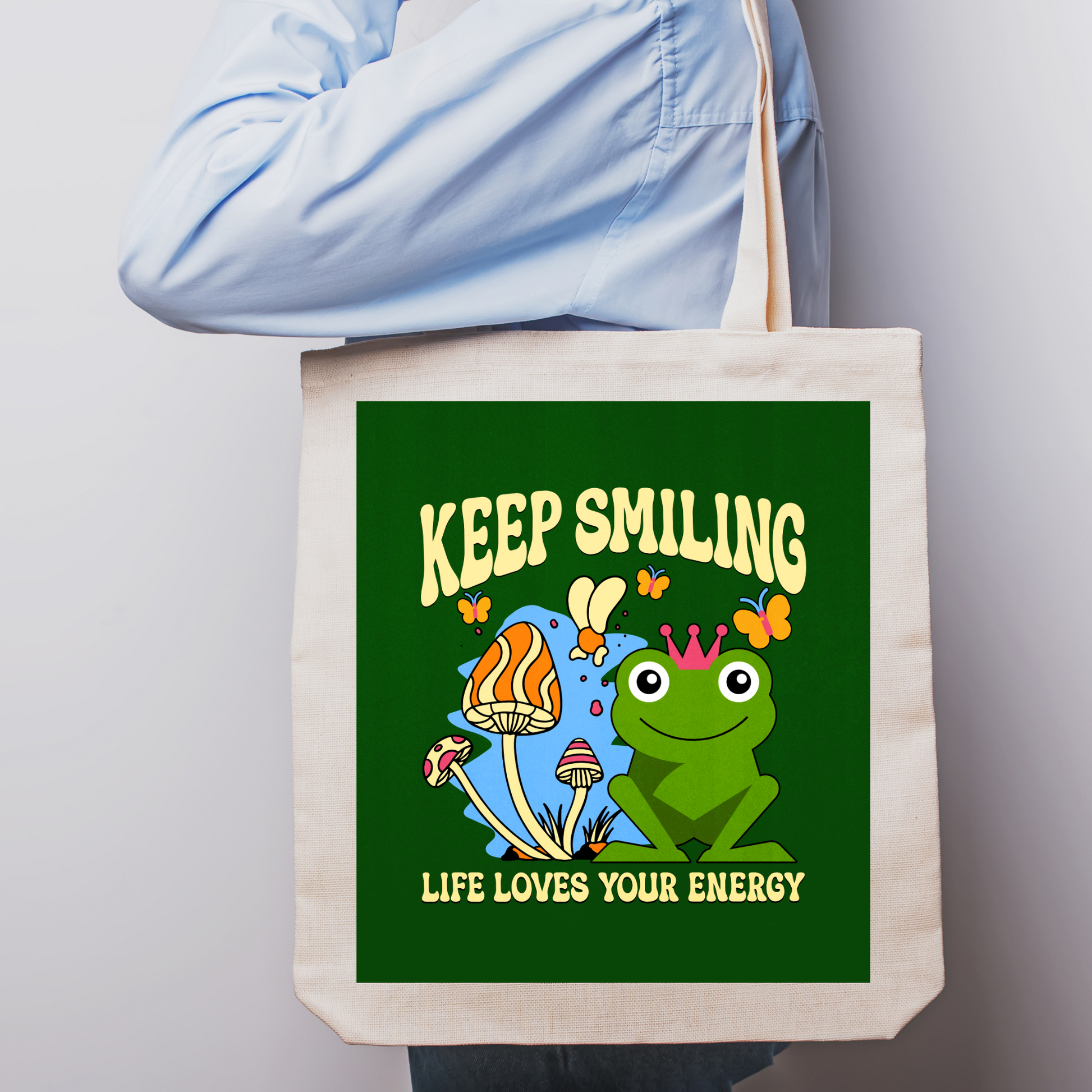 Lifestyle shot of frog and mushrooms tote bag in use for everyday activities.